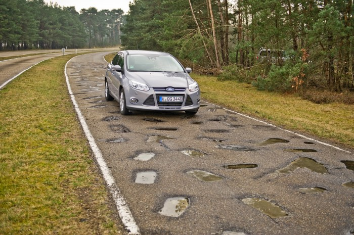 A car moving over a bumpy proving ground road